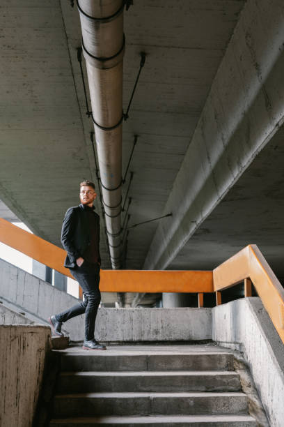 istock Well-dressed young businessman walking down the bridge stairs 1331273900