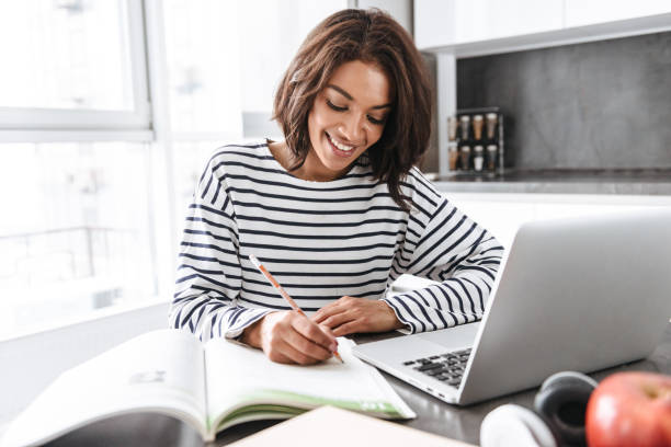 istock Attractive young african woman using laptop computer 1331274091