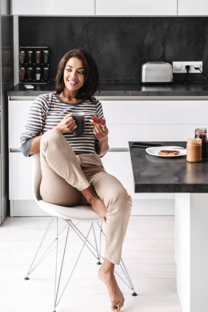istock Beautiful young african woman having breakfast 1331274899