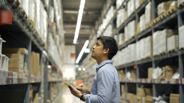 istock Man worker checking products with tablet in warehouse. 1331280602