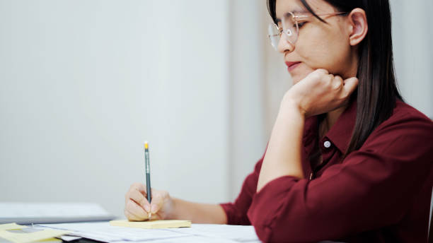istock Close up woman hand doing document at home 1331280623