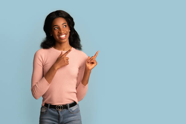 istock Excited African American Lady Pointing Aside At Copy Space On Blue Background 1331281380