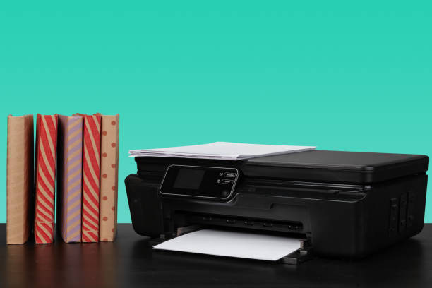 istock Home laser printer on desk against green background 1331281801