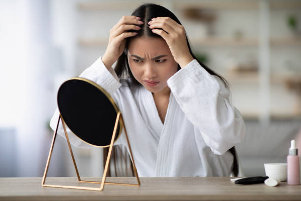 istock Angry asian lady checking her grey hair 1331283171