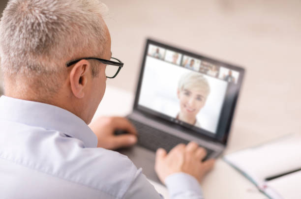 istock Senior man in glasses making online video call at home 1331283300