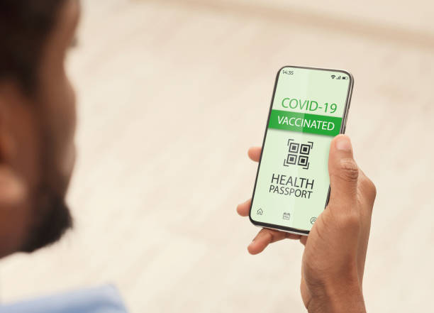 istock Black man using smartphone with digital health passport for covid-19 1331283372