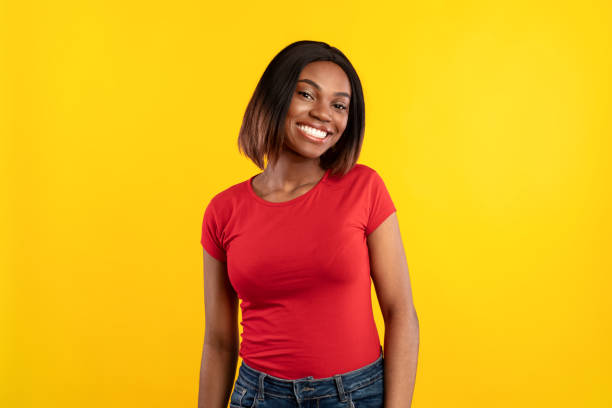 African American Lady Posing Smiling To Camera Over Yellow Background