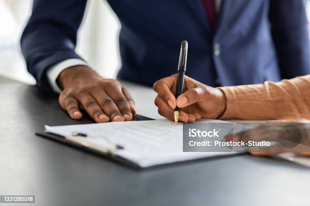 Contract Signing Female Customer Sign Papers In Dealership Office Closeup Shot Stock Photo - Download Image Now
