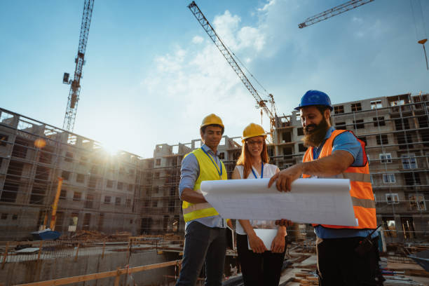 istock Senior engineers and architects looking at blueprint on construction site 1331286917