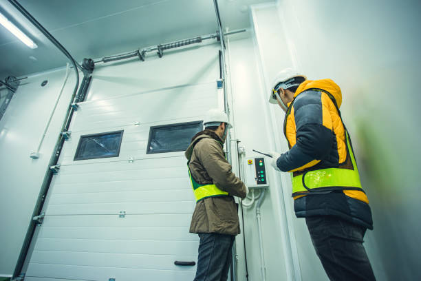 Technician working inspection control at cool warehouse. Two technician working inspection control system for lift in cold warehouse. thai door stock pictures, royalty-free photos & images