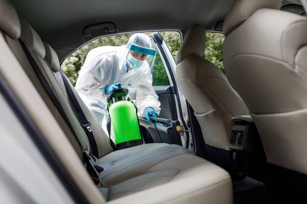 istock Specialist cleaner wearing hazmat suite, personal protective equipment PPE using chemical alcohol spray 1331287261