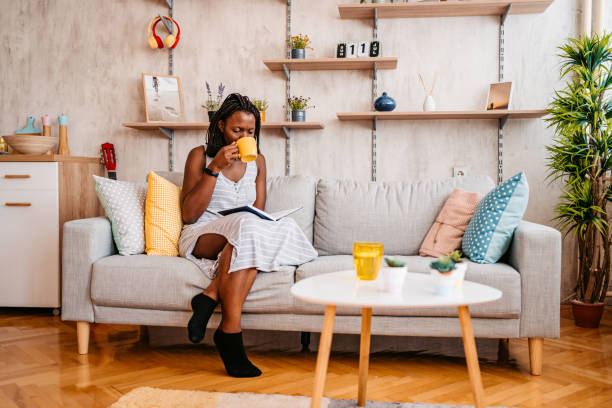 istock Woman At Home sitting On Reading Book And Drinking Coffee 1331287363