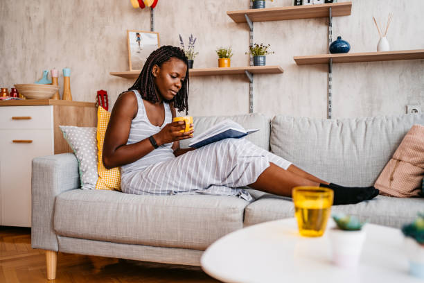 istock Woman At Home Lying On Reading Book And Drinking Coffee 1331287430