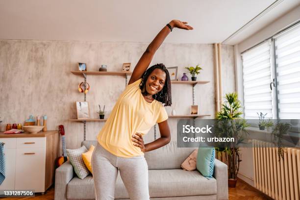 Beautiful Woman Stretching Before Training At Home Stock Photo - Download Image Now - Stretching, Routine, Morning