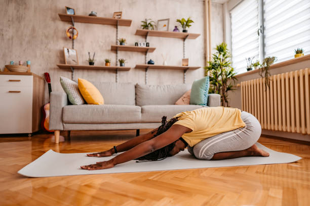 istock Young woman doing yoga at home 1331288352