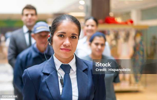 Security Guard With A Group Of Workers At A Shopping Mall Stock Photo - Download Image Now