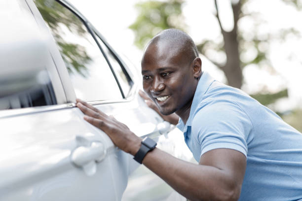 istock Excited black man buying new car, checking surface 1331288432