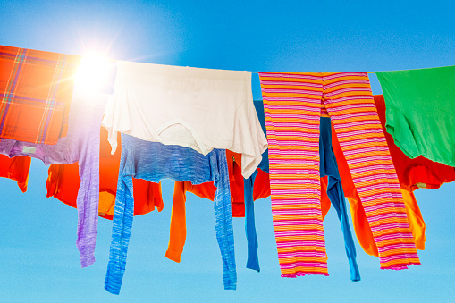 Colorful laundry on the clothesline under a clear blue sky
