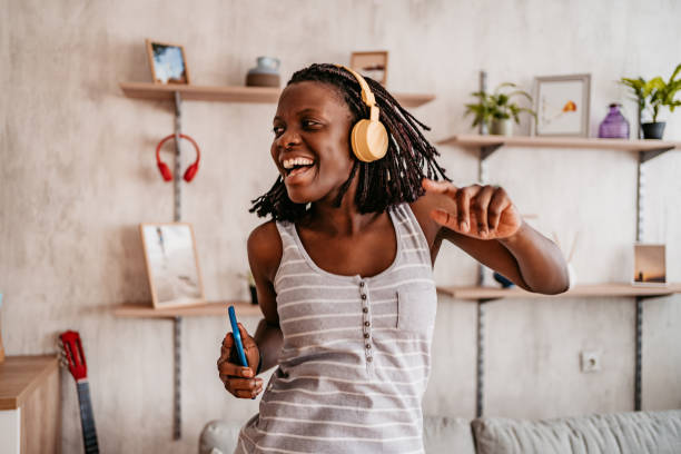 istock Woman singing and dancing at home 1331288506