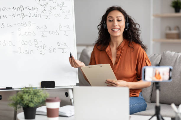 istock Female teacher in headset explaining trigonometric functions to students online 1331291676