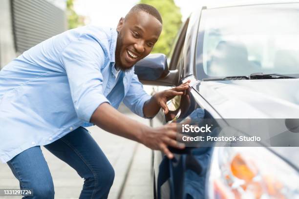 Happy African American Guy Touching His New Auto Stock Photo - Download Image Now - Car, New, Happiness