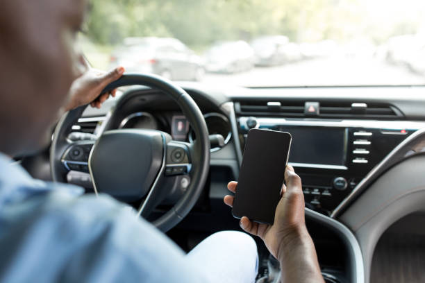 istock Unrecognizable black man driver holding smartphone, mockup 1331291879