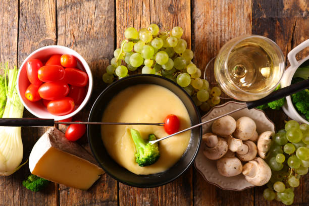istock cheese fondue with vegetable and wine glass 1331292147