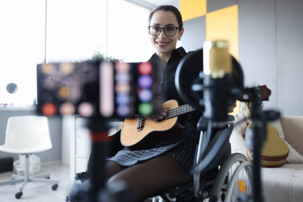 istock Smiling woman is recording guitar playing closeup 1331292164