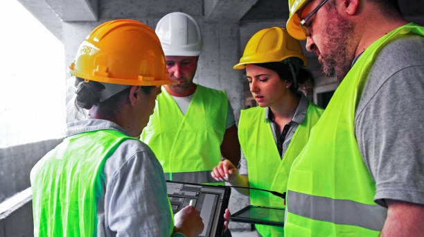 istock Engineers and an entrepreneur working on construction site with tablet, checking the work progress. 1331292939