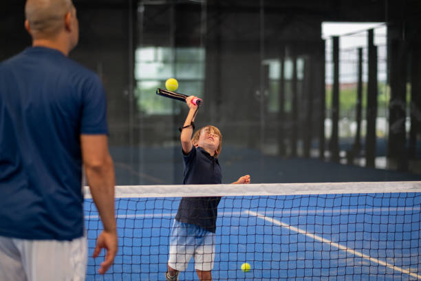istock Monitor teaching padel class to man, his student - Trainer teaches boy how to play padel on indoor tennis court 1331293168