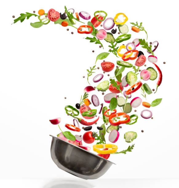 istock Fresh vegetables flying into steel plate, isolated on white background 1331293565