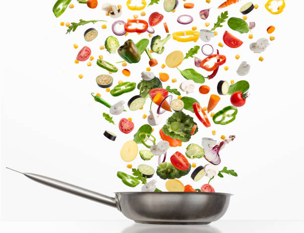 istock Fresh vegetables flying into steel pan, isolated on white background 1331294688