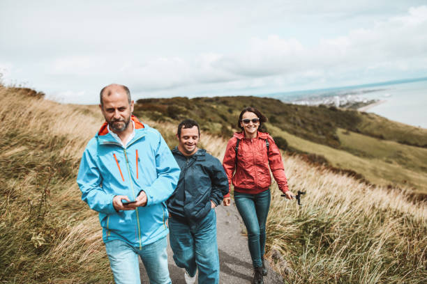 Happy Siblings Taking Brother With Down Syndrome For A Walk