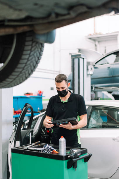 istock Mechanic wearing surgical mask using Diagnostic machine tools for car stock photo 1331297610