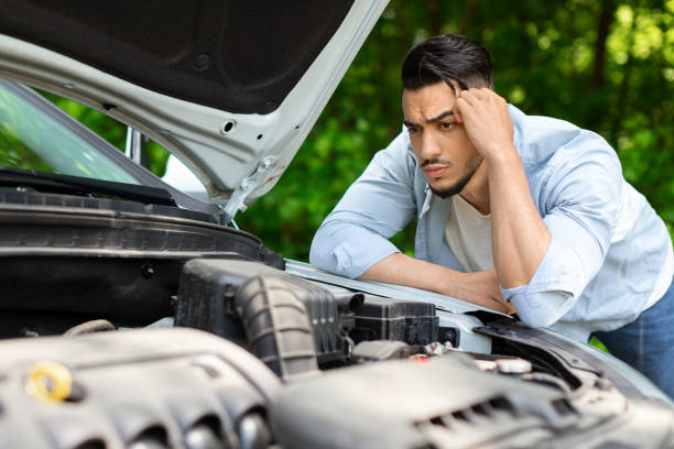 istock Puzzled arab man leaning on open car hood 1331298383