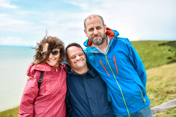 istock Happy Siblings Embracing Brother With Down Syndrome 1331299294