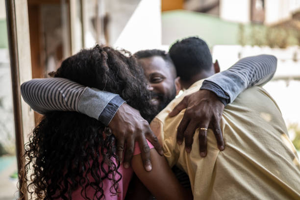 istock Father embracing son and daughter at home 1331299560