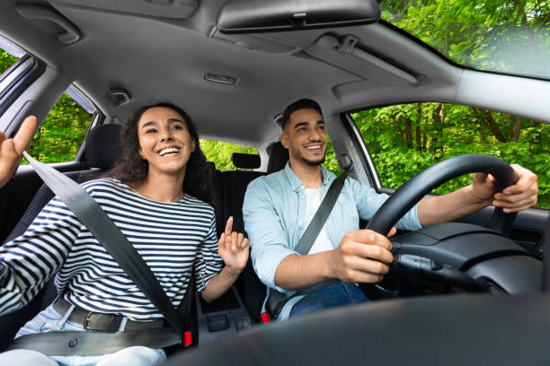 Emotional mixed race couple having fun while car trip