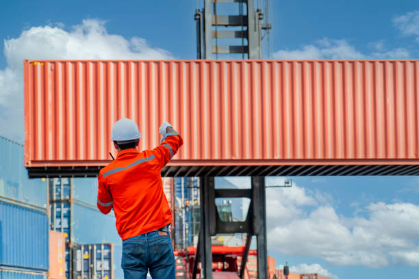 istock Engineers are overseeing the transportation of cargo with containers inside the warehouse. Container in export and import business and logistics. 1331301071