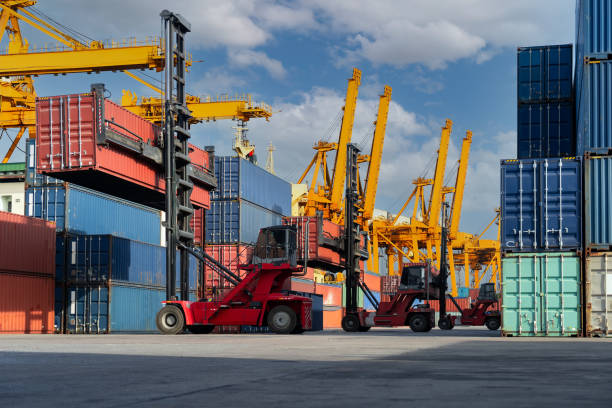 istock Engineers are overseeing the transportation of cargo with containers inside the warehouse. Container in export and import business and logistics. 1331301080
