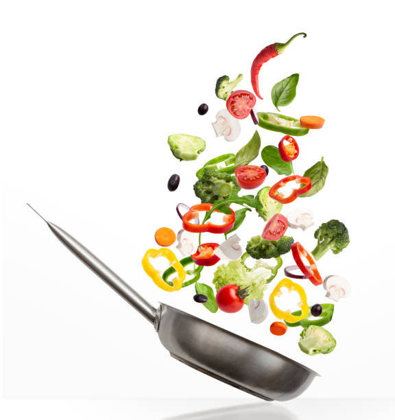istock Fresh vegetables flying into pan, isolated on white background 1331304069
