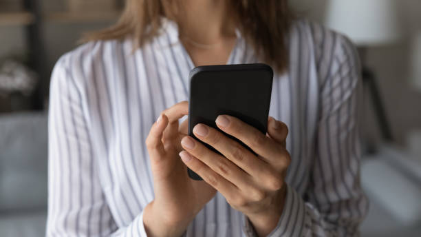 istock Woman texting message on cellphone closeup view 1331304087