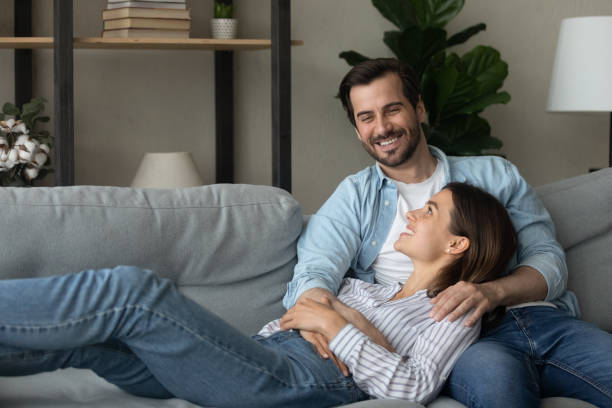 istock Young couple relaxing on comfy couch in living room 1331304109