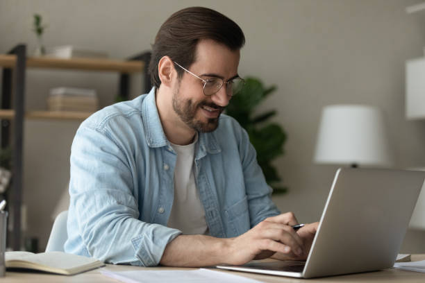 istock Man sit at desk texting on laptop working from homeoffice 1331304128