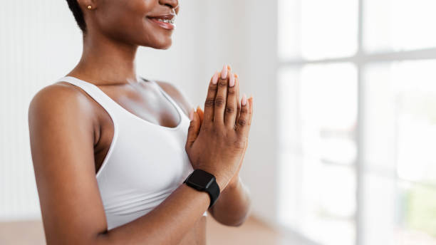 istock Black female meditating keeping hands together in prayer pose 1331304332