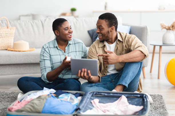 istock Cheerful African American Tourists Using Tablet Booking Vacation At Home 1331305011
