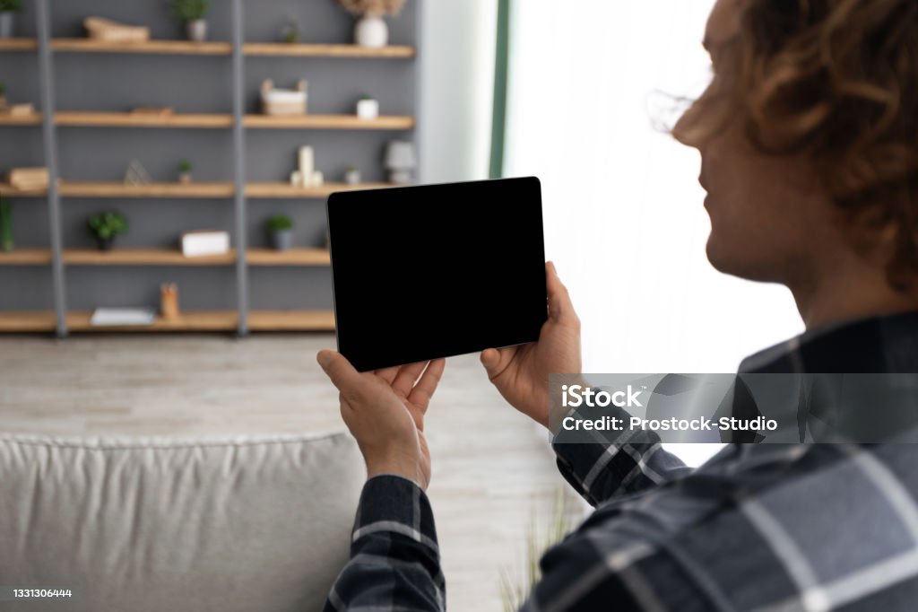 Person Using Tablet Computer Man Using Tablet Computer With Empty Screen Controlling House Indoors ...