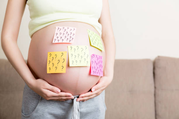 istock Pregnant woman belly with question mark. Pregnancy and thinking problem 1331308208