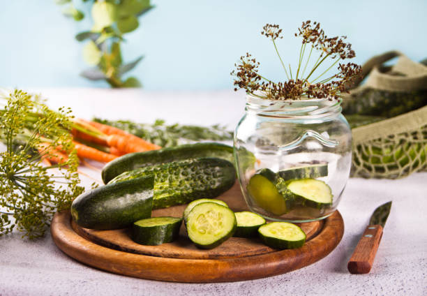 istock Pickled marinated cucumbers in a kitchen table with dill, spices and garlic 1331309371