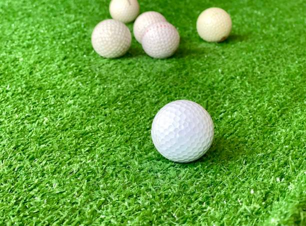 istock Golf balls on green grass of golf course background evening light shadow, for banner copy space for text 1331309779